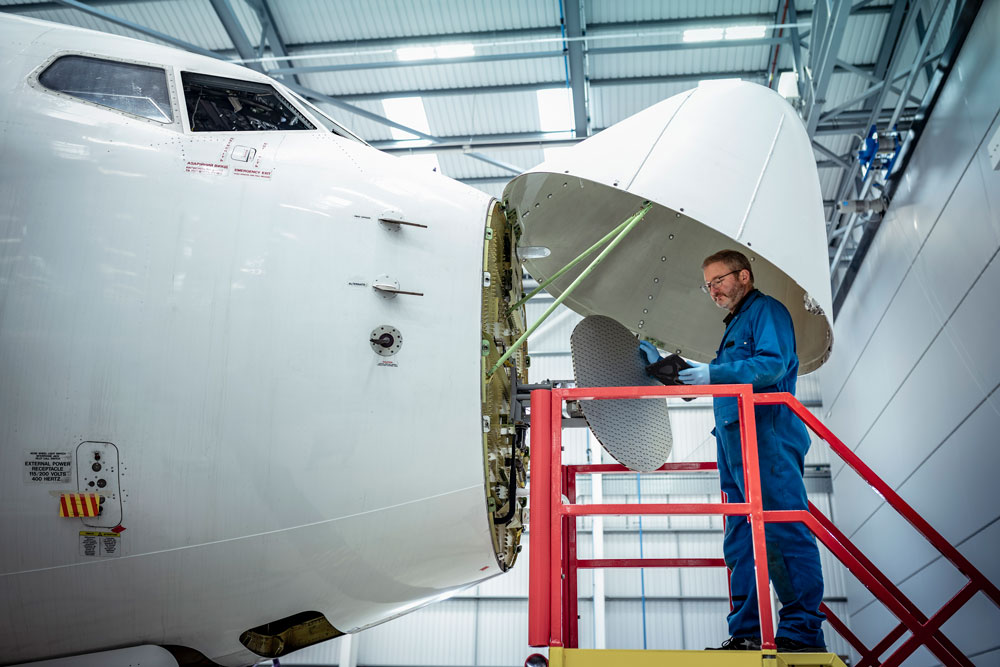 Avionics technician inspecting aircraft